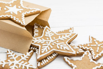 Gingerbread cookies in a packing pag on a white wooden backgroun