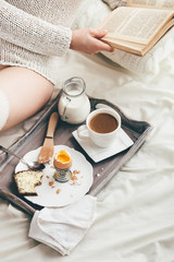 Fototapeta na wymiar Woman having breakfast in bed. Window light