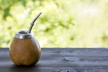yerba mate in gourd matero on wooden table