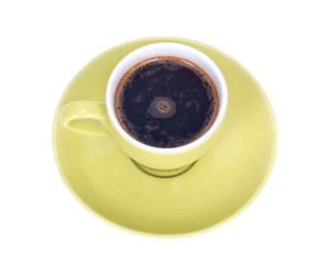 Black coffee in green cup on saucer separated on white background