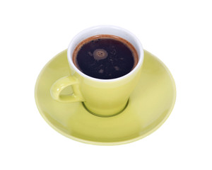 Black coffee in green cup on saucer separated on white background