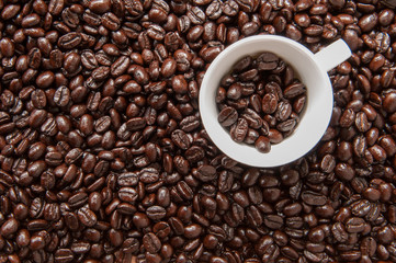 Coffee mug on coffee beans.