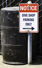 Dive Shop parking sign on a beach