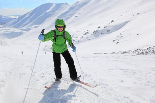 Young woman rises in the snowy slopes on skis in Hibiny mountains.