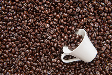 Coffee mug on coffee beans.