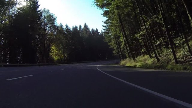 GoPro perspective of car driving on mountain road