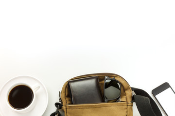 Top view the bag,wallet,mobile phone,sunglasses,black coffee on white background.