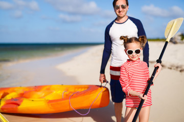 Family kayaking at tropical ocean