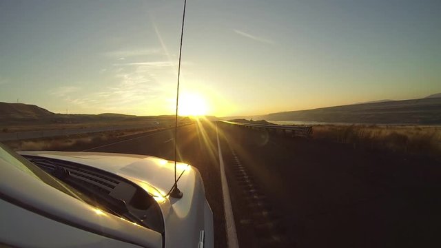 GoPro perspective of car driving on sunset highway