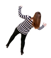 Balancing young woman. Girl in a striped jacket falls balancing on his left leg.