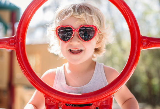 Portrait of young boy wearing heart shaped sunglasses 