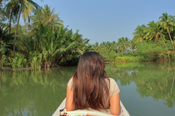 Asian tan skin woman lay down relax by riverside with green natural tropical forest view scene, spa concept, Mae Klong river, Amphawa, Samut Songkhram, Thailand