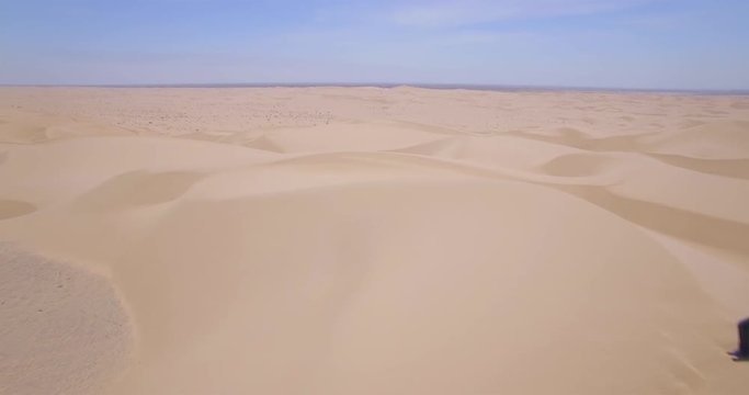 Photographer Top Sand Dunes / Multiple aerial clips of a photographer standing on top of a desert sand dune.