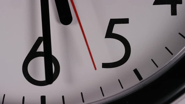 Close up of a clock face at 5:30pm