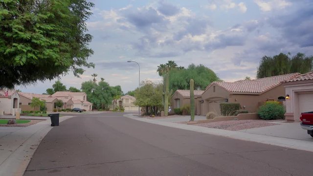 An establishing shot of a typical Arizona-style residential neighborhood.  	