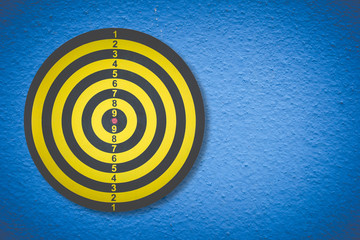 Darts Board on color concrete texture ,symbol of target ,business concept 