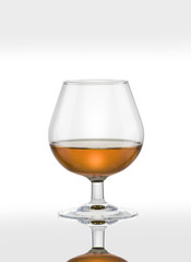 Cognac glass with brandy on a white background.