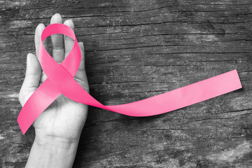 Breast Cancer pink ribbon awareness on woman hand, bow color concept raising awareness campaign on...