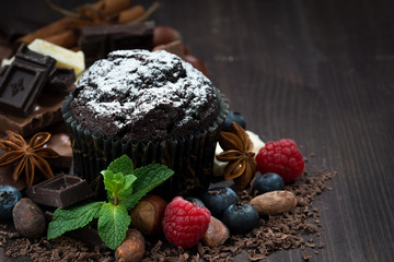 chocolate muffins with icing sugar and fresh sweet ingredients 