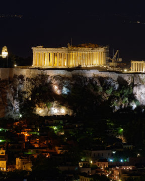 Athens Greece, night view of Parthenon and Plaka old neighborhood
