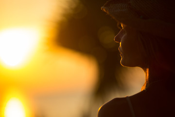 young woman staying back of the head in summer light