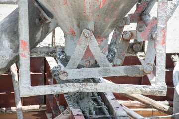 worker pouring  concrete  works at construction site