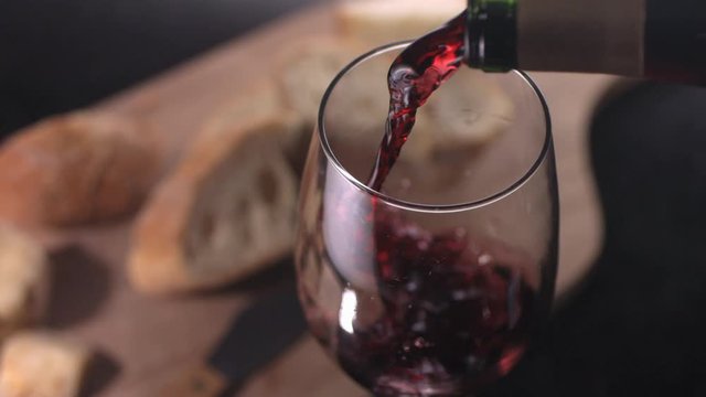 Slow motion shot of red wine being poured