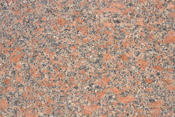 Polished bright red granite texture with natural pattern. Background of natural stone.