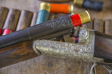 Vintage hunting gun with shotgun shells. Close-up