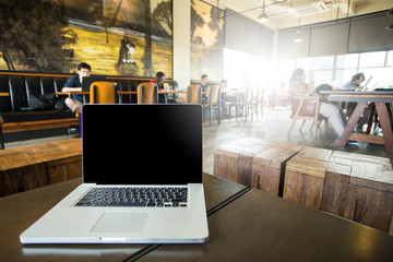 laptop for blank and coffee on a table showing break or breakfas