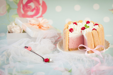 Fototapeta na wymiar Tiramisu cake charlotte decorated with raspberry