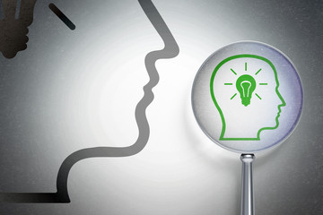 Advertising concept:  Head With Lightbulb with optical glass on digital background