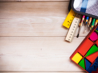 Primary school supplies on the wooden background. School concept