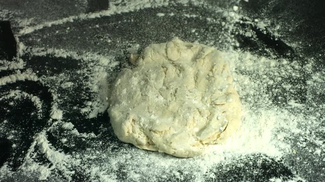 Slow motion shot of dough and flour
