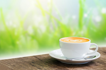 Coffee cup in coffee time on green background