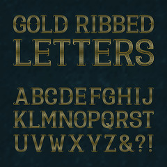 Golden ribbed letters with flourishes on blue marble surface. Horizontal stripes vintage font. Isolated latin alphabet.