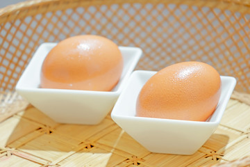 Chicken Eggs on White Ceramic Bowl in Rattan Basket