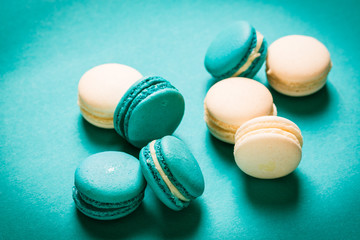 Fresh macaroons on wooden table ,vintage filter