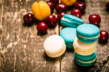 Fresh macaroons on wooden table ,vintage filter