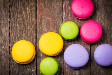 Fresh macaroons on wooden table ,vintage filter