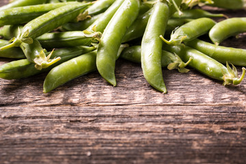 green peas on wooden table ,healthy concept