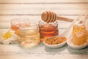 healthy honey composition, wooden background, vintage filters
