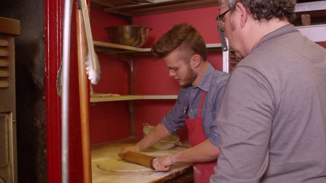 Chefs at restaurant making pizza - 4K