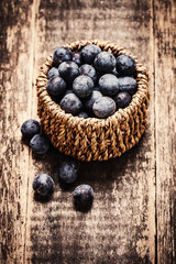 berries in basket on wooden vintage table,healthy food.
