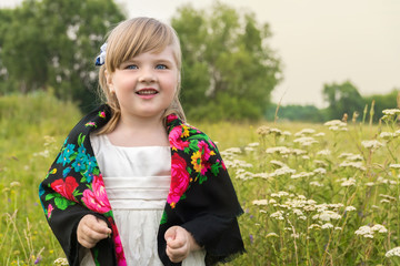 girl standing in a meadow