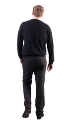 back view of walking  business man.  Isolated over white background. Rear view people collection.  backside view of person.  stylish man in black sweater and pants went off