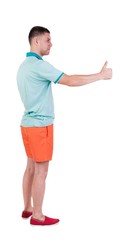 Back view of  man in shorts shows thumbs up.   Rear view people collection.  backside view of person.  Isolated over white background.