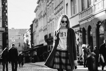 Black and white picture of chic young girl dressed in casual sty