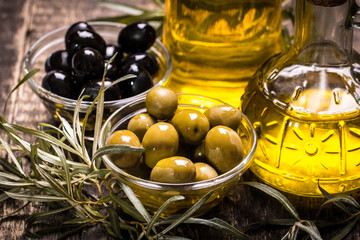 Olive oil on wooden table , food concept