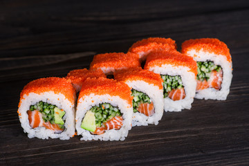 Sushi roll on wooden background . They were 8 pieces .